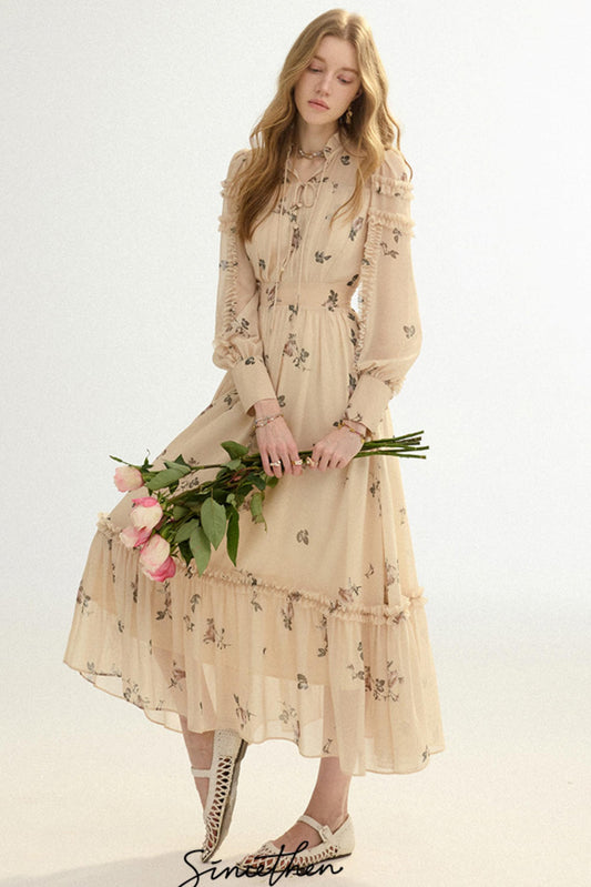 Woman in a beige floral dress holding flowers on a white background