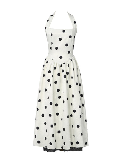 A white halter-neck dress with a black polka dot pattern, shown against a plain white background.