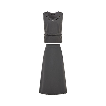 A dark gray two-piece set consisting of a sleeveless cropped top with decorative cutouts and a matching high-waisted A-line skirt, shown against a plain white background.