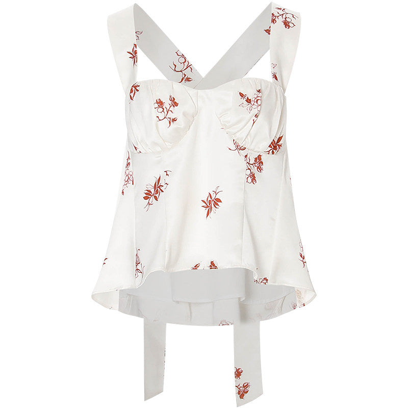 White top with red floral patterns on a white background