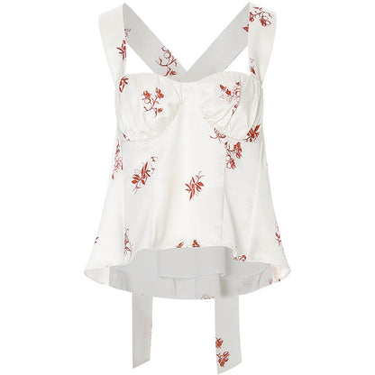 White top with red floral patterns on a white background
