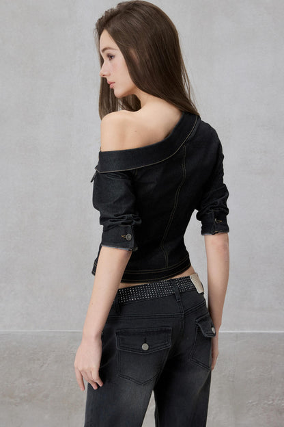 Woman wearing a black off-shoulder top and black pants against a gray background