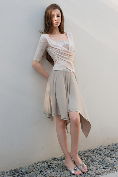 Woman wearing a beige dress against a plain background