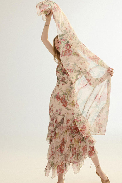 Woman holding a floral scarf with a plain background