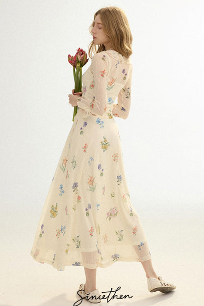 Woman wearing a floral dress holding tulips against a white background