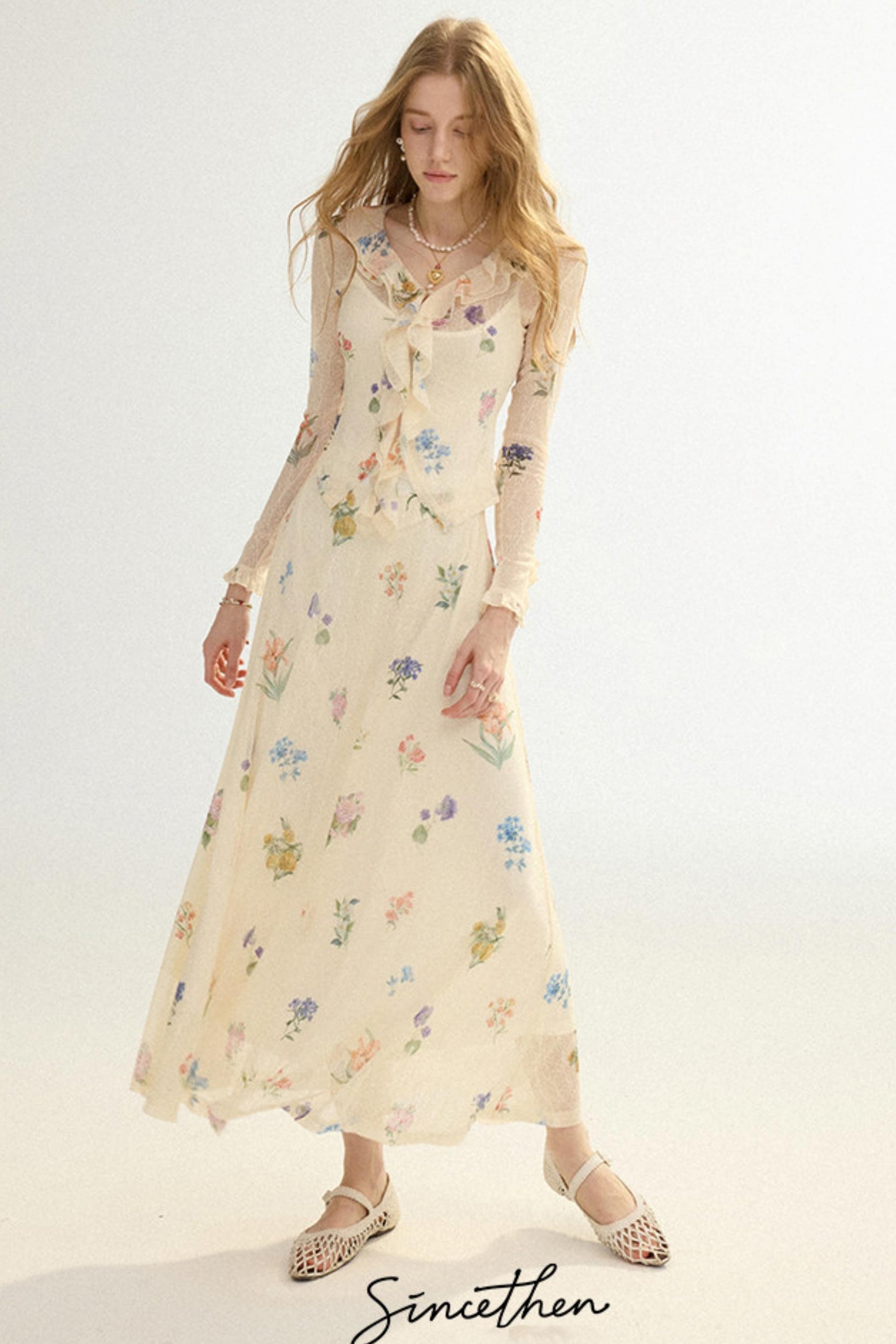 Woman wearing a floral dress on a white background with 'Sineithen' branding.