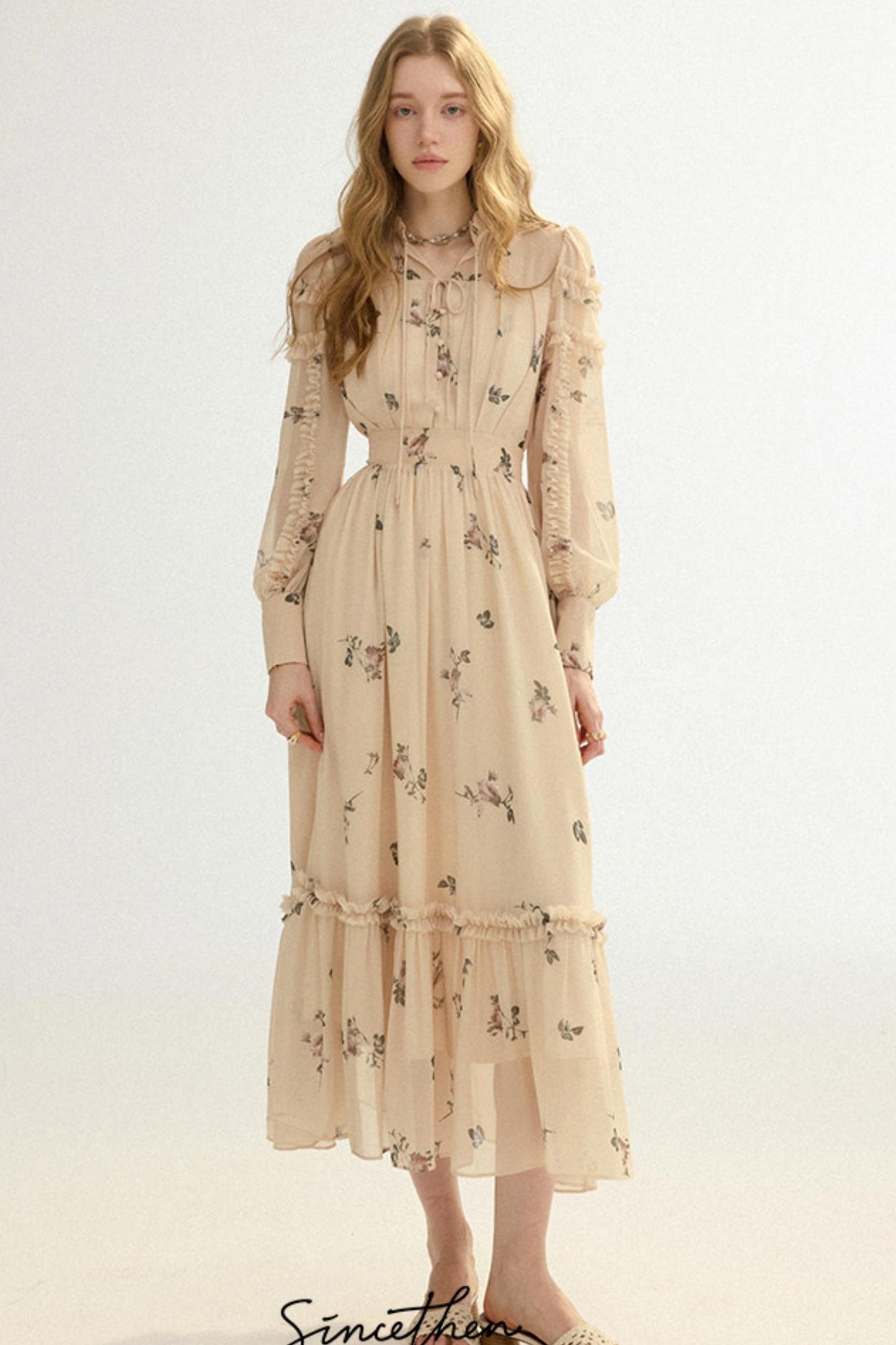 Woman wearing a beige floral dress on a white background