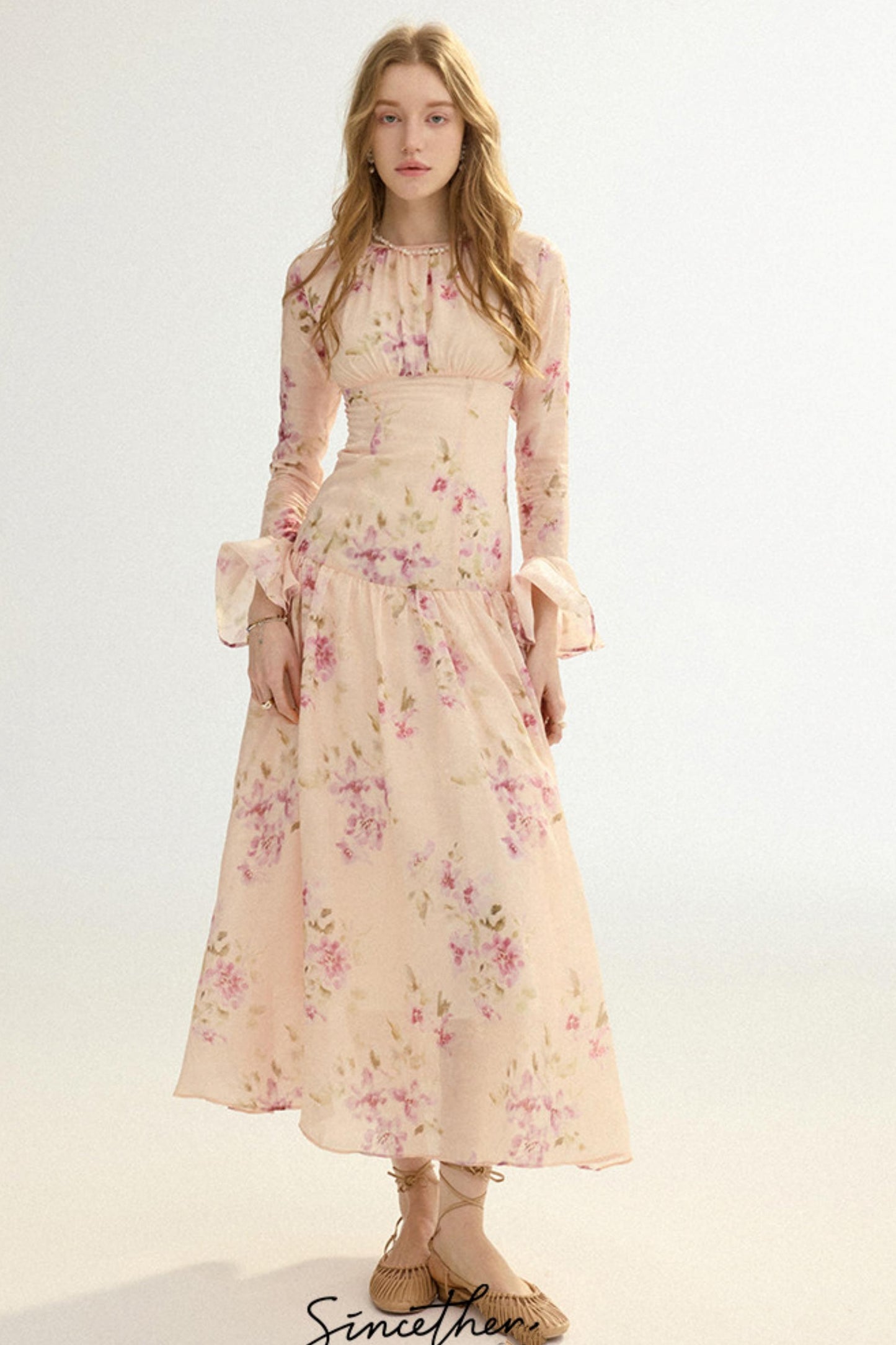 Woman wearing a floral dress on a white background