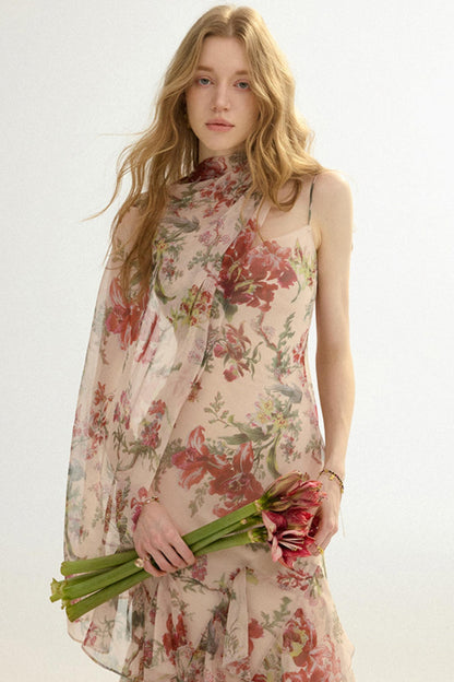Woman wearing a floral dress holding flowers against a white background
