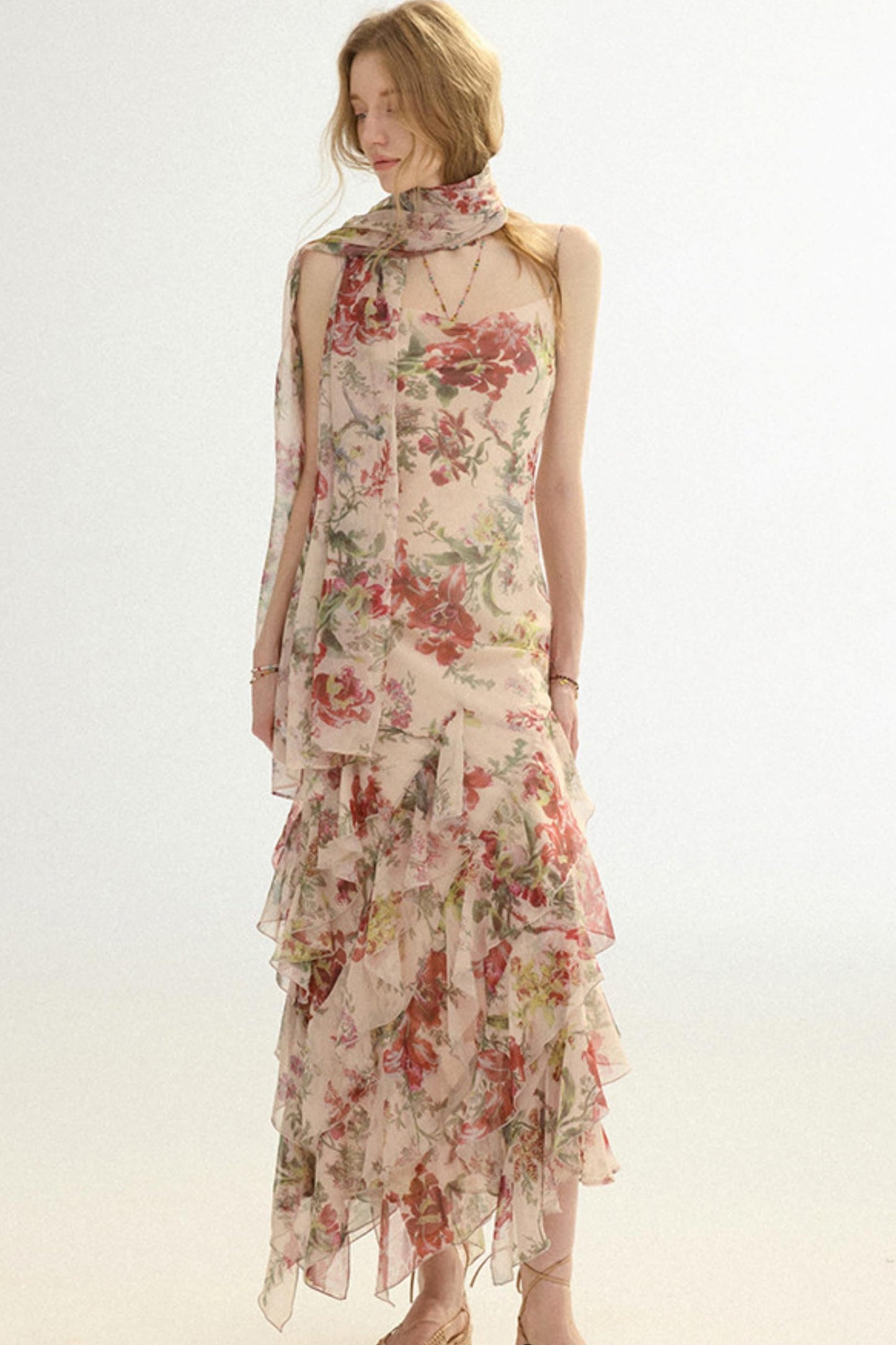 Woman wearing a floral dress with a plain background