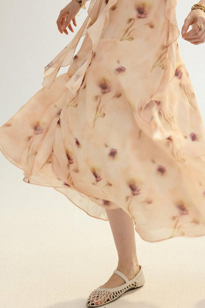 Woman wearing a flowing dress with a pattern on a plain background
