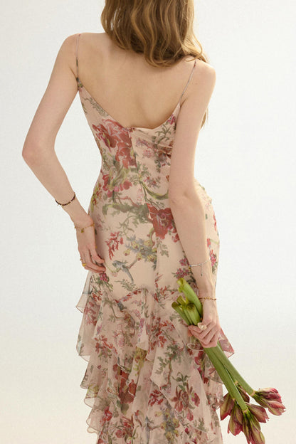 Woman wearing a floral dress holding tulips against a light background