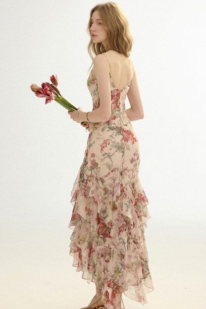 Woman in a floral dress holding flowers against a white background