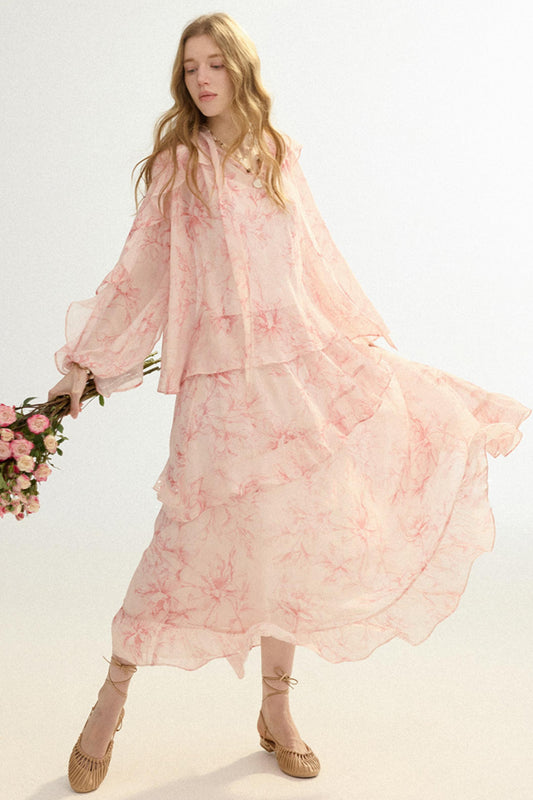 Woman wearing a pink floral dress holding flowers on a white background