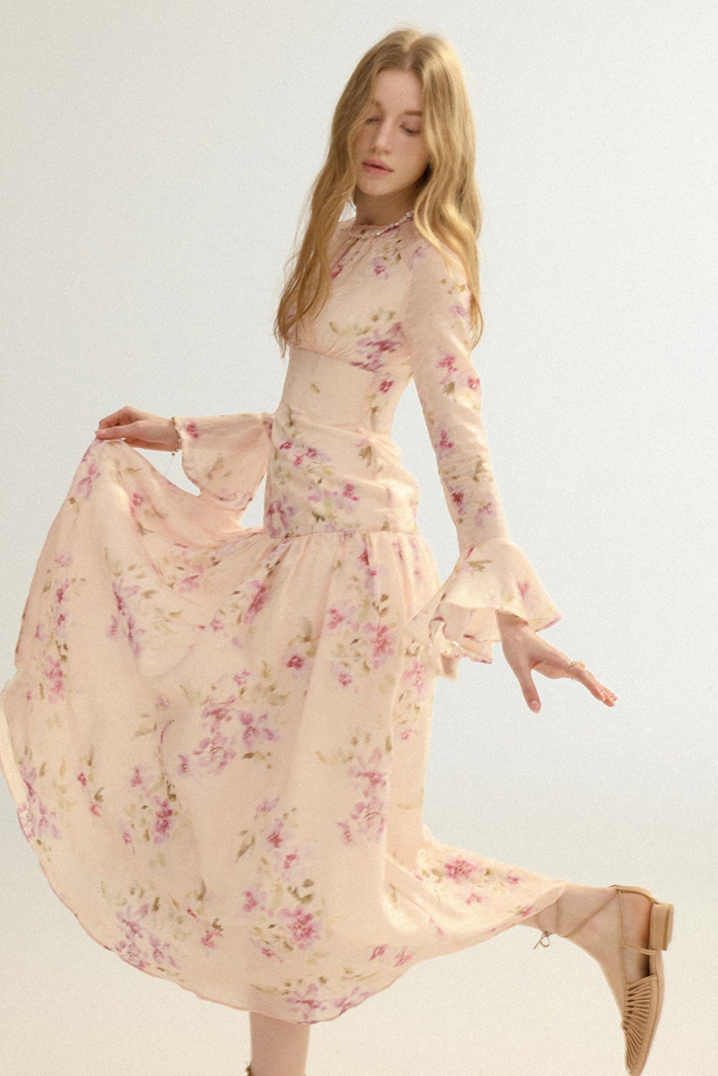 Woman wearing a floral dress on a plain background