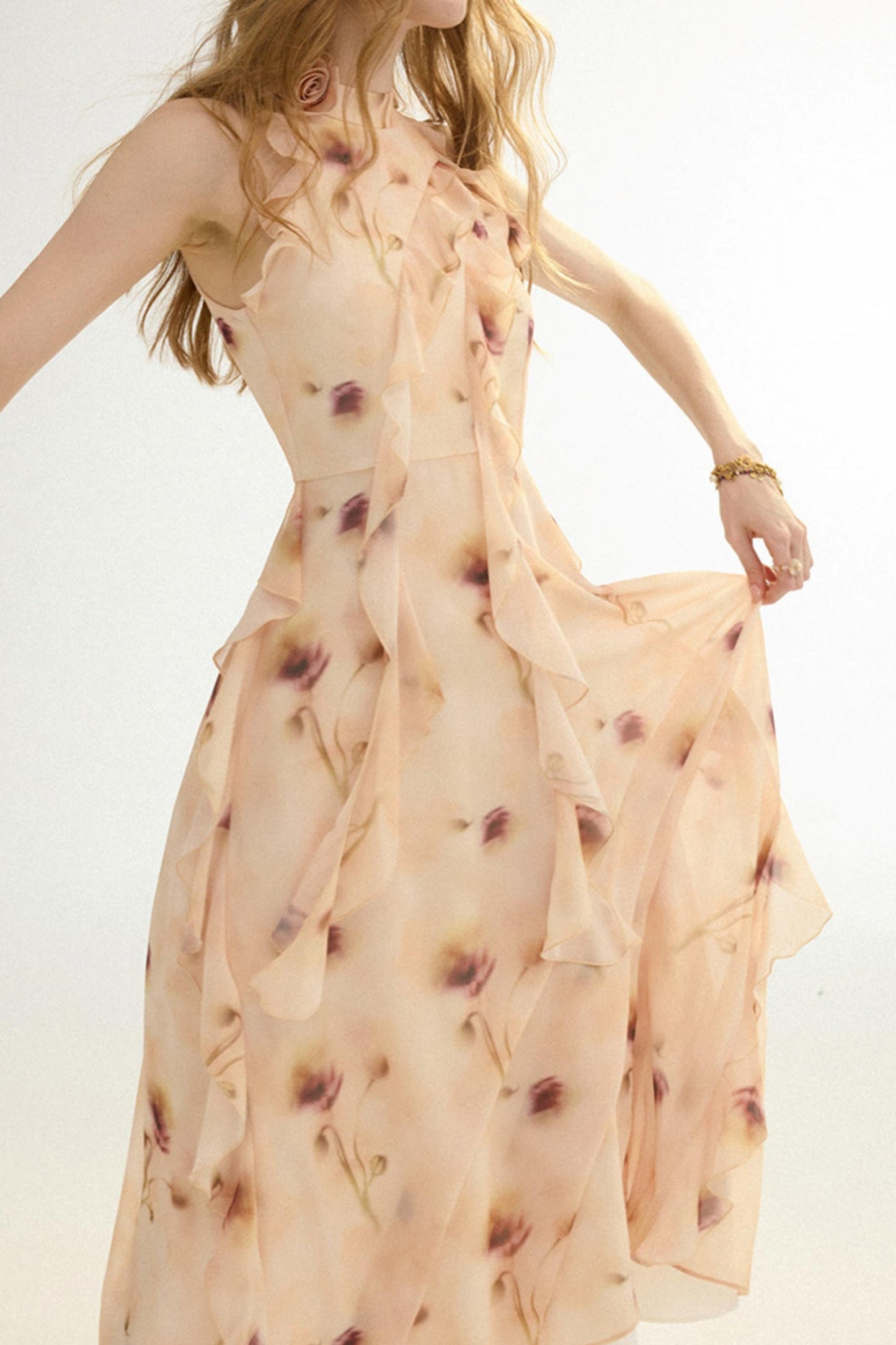 Woman wearing a floral dress with a plain background