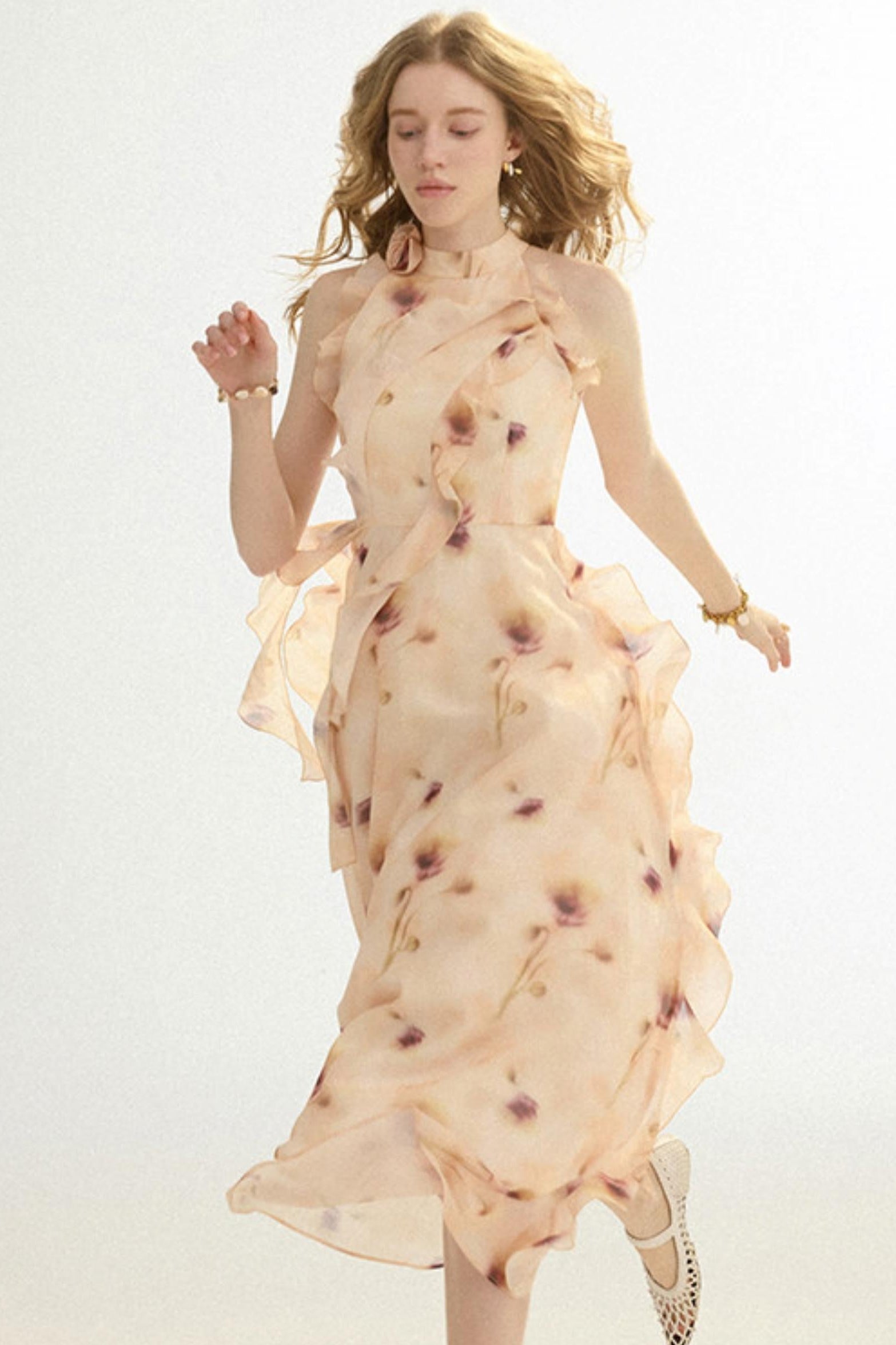 Woman wearing a floral dress with 'Sine then' branding on a light background