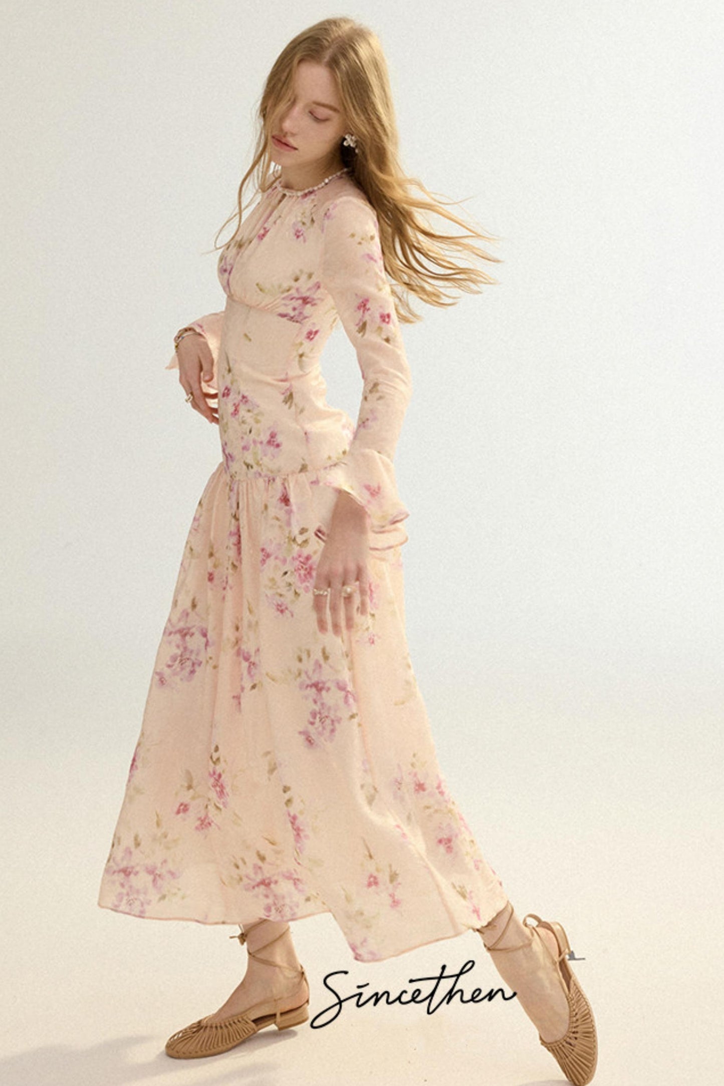 Woman wearing a floral dress with a plain background