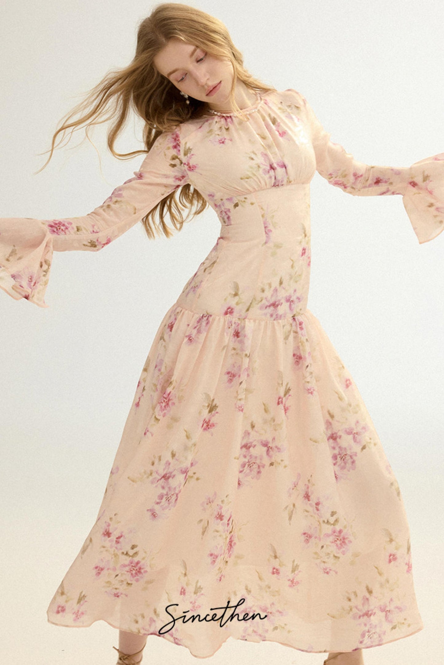 Woman wearing a floral dress with a plain background