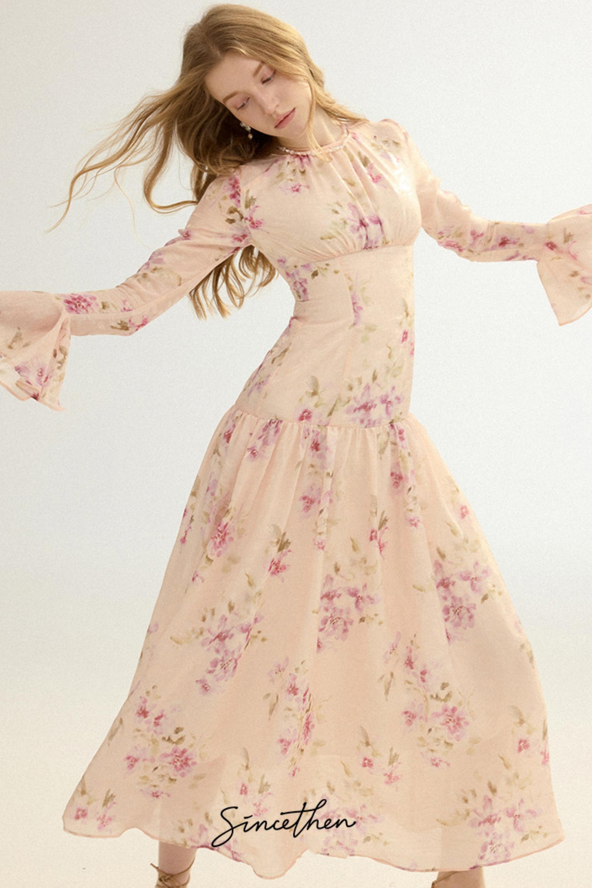 Woman wearing a floral dress with a plain background